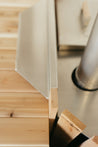 Close-up of a wooden drink tray with a stainless steel edge, showcasing natural cedar wood grain.