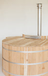 Cedar lid for a wood fired hot tub, featuring a smooth wooden surface and stainless steel chimney.