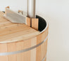 Cedar wood drink tray attached to a wood fired hot tub, featuring a stainless steel edge and smooth finish.