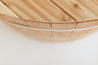 Close-up of a wooden cedar lid with a smooth finish and angled slats, showcasing natural wood grain.