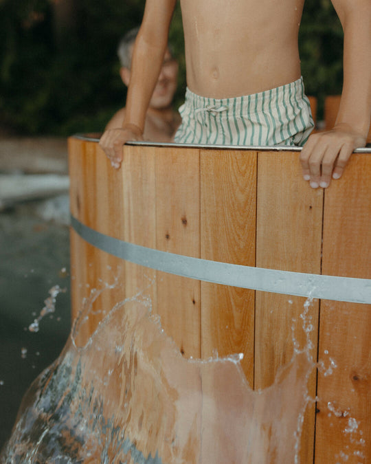 Wood burning hot tub with kid in it