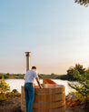 Cedar hot tub with man heating it